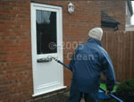 An Aqua Clean cleaner cleaning one of our customers uPVC doors