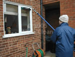 An Aqua Clean cleaner cleaning one of our customers windows